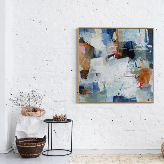 Abstract painting on a white wall with minimal decor