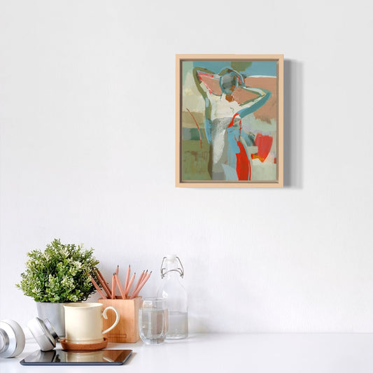 Framed abstract painting on a wall above a desk with office supplies.