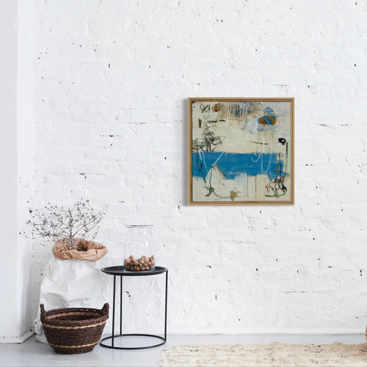 Framed abstract art on a white wall with minimal decor