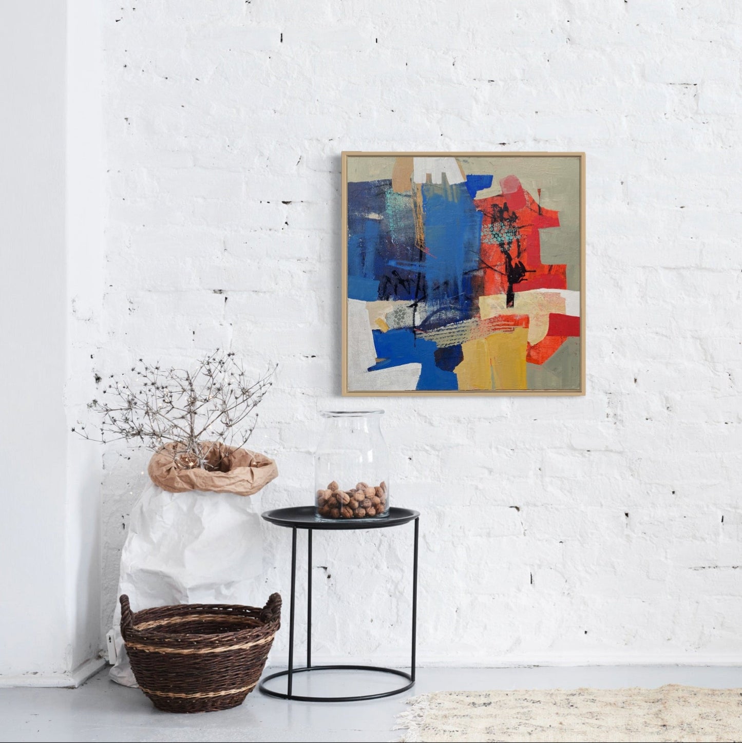 Abstract painting on a white wall with minimal decor