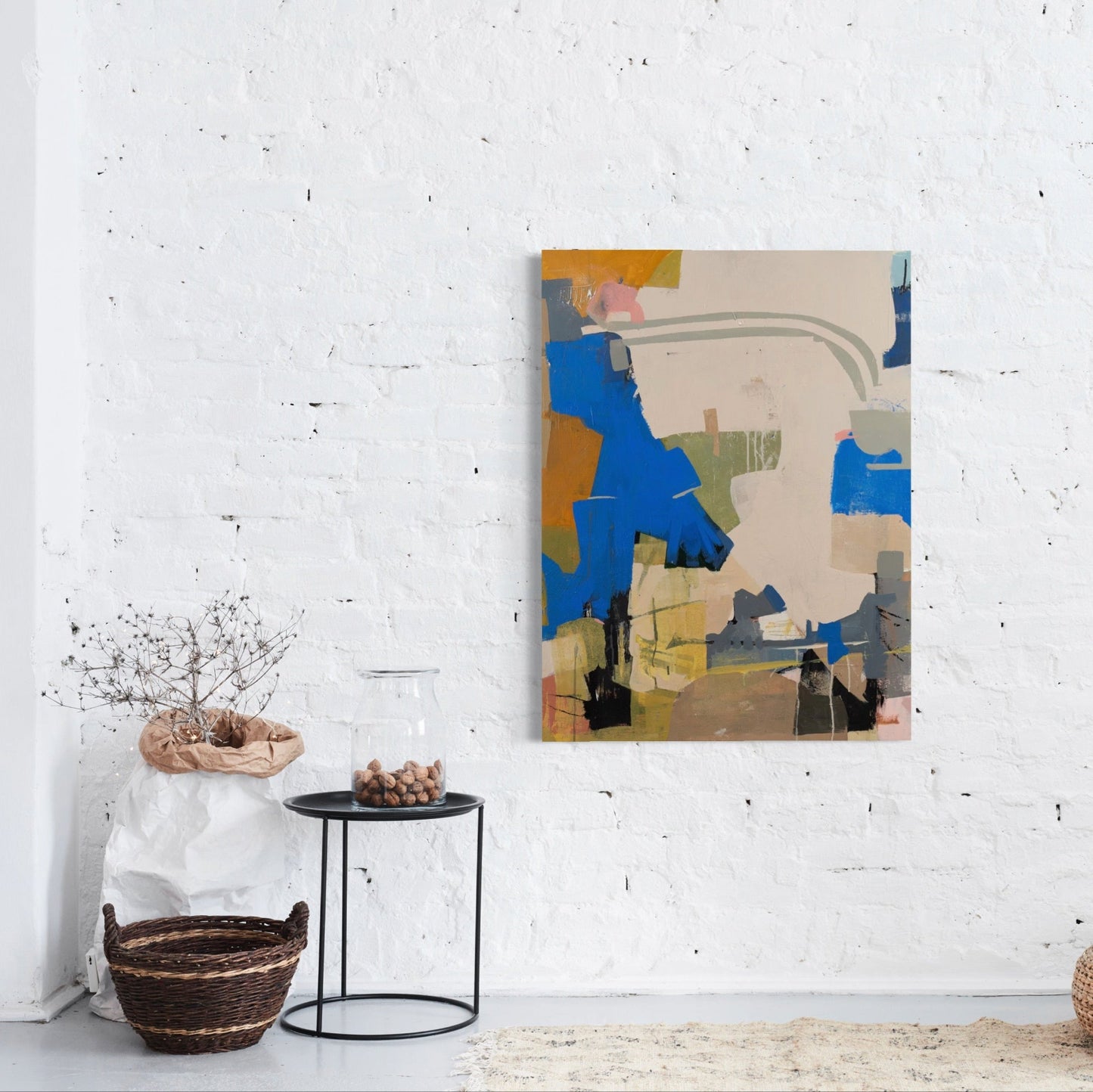 Abstract painting on a white wall with minimal decor