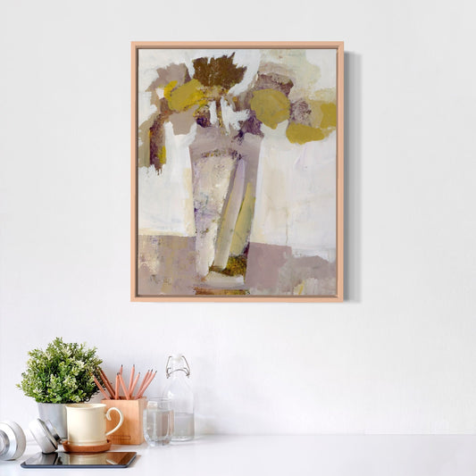 Abstract art print in a wooden frame on a white wall above a desk with office supplies.