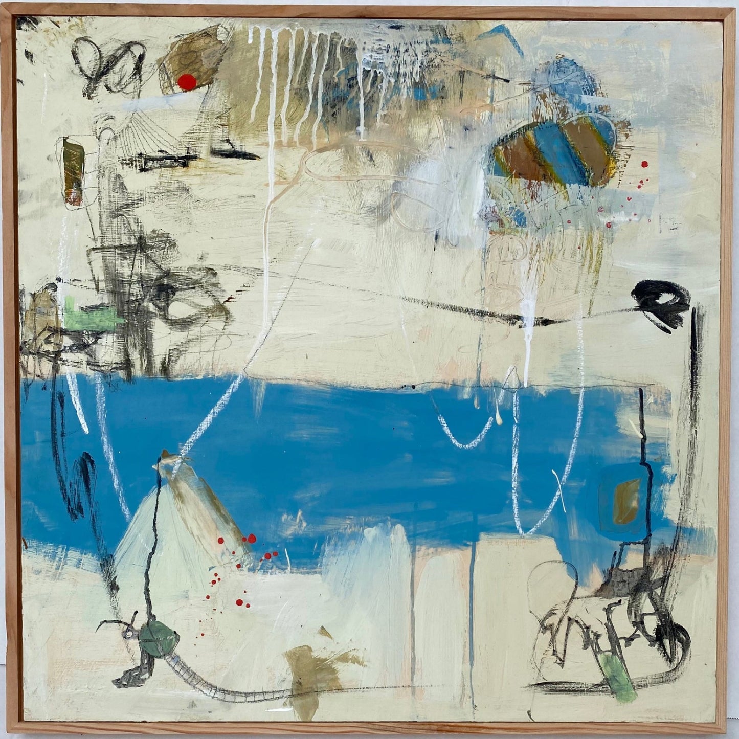 Abstract artwork with a blue section and various shapes and colors on a beige background