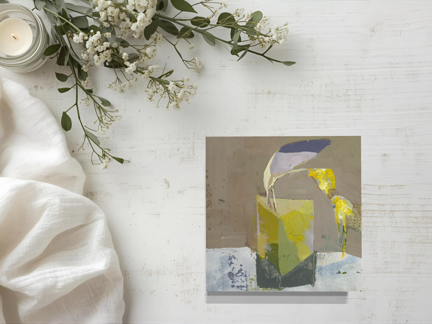 Abstract painting on a white surface with flowers and a candle