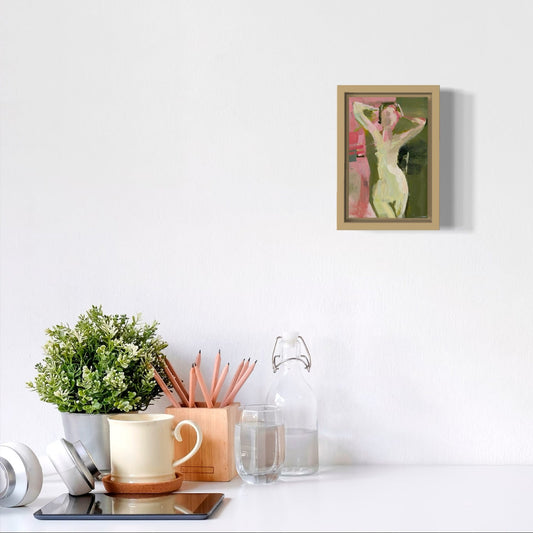 Framed artwork on a white wall with decorative items below